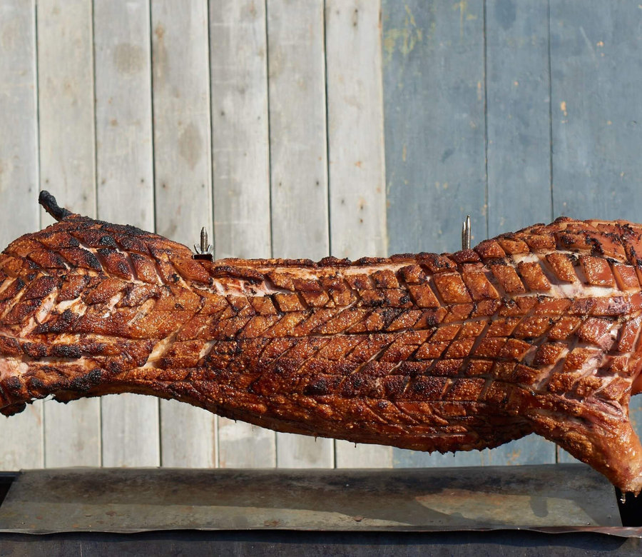 Hog roast cooking on a spit